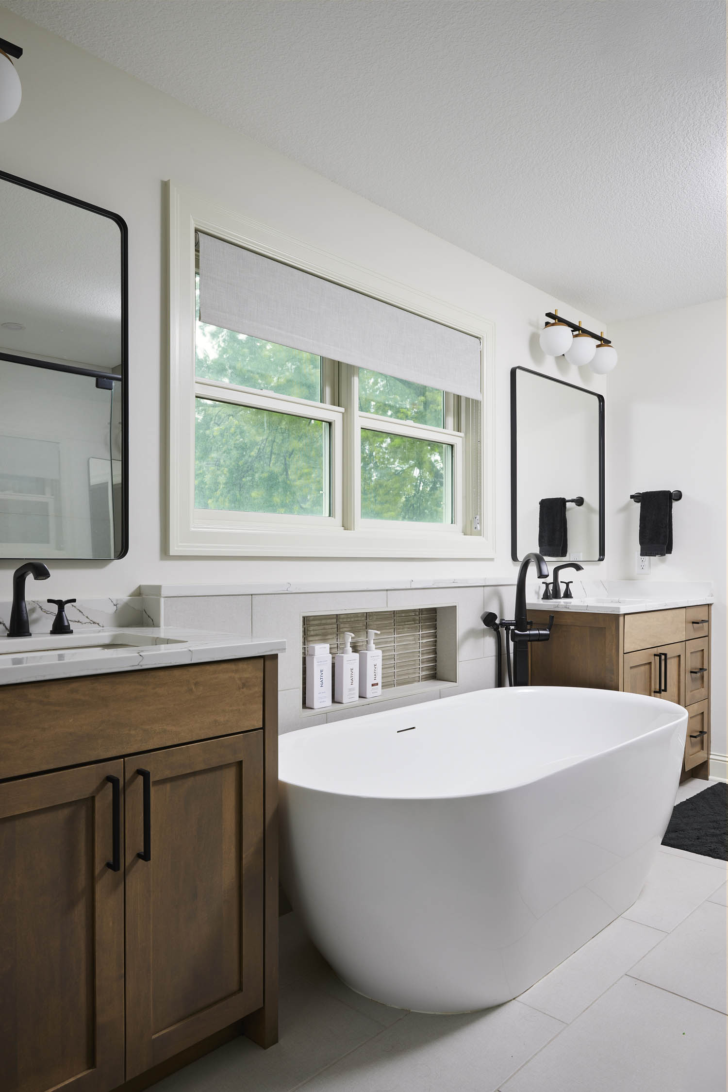 Owners' Suite Bathroom Remodel in St. Louis Park, Minnesota featuring his and her vanities, white quartz countertops and maple cabinets with a gray stain.