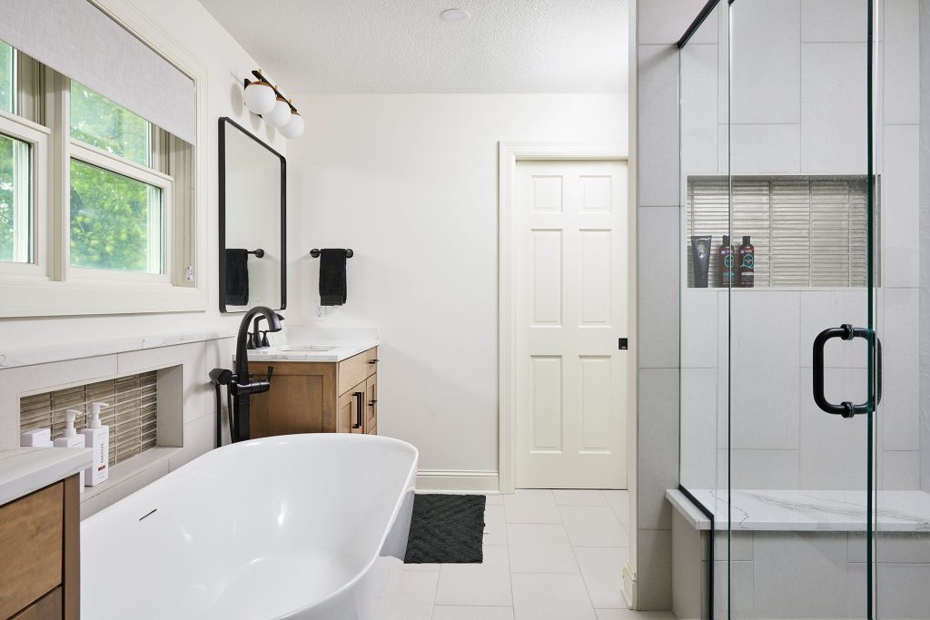 Owners' Suite Bathroom Remodel in St. Louis Park, Minnesota featuring his and her vanities, white quartz countertops and maple cabinets with a gray stain.