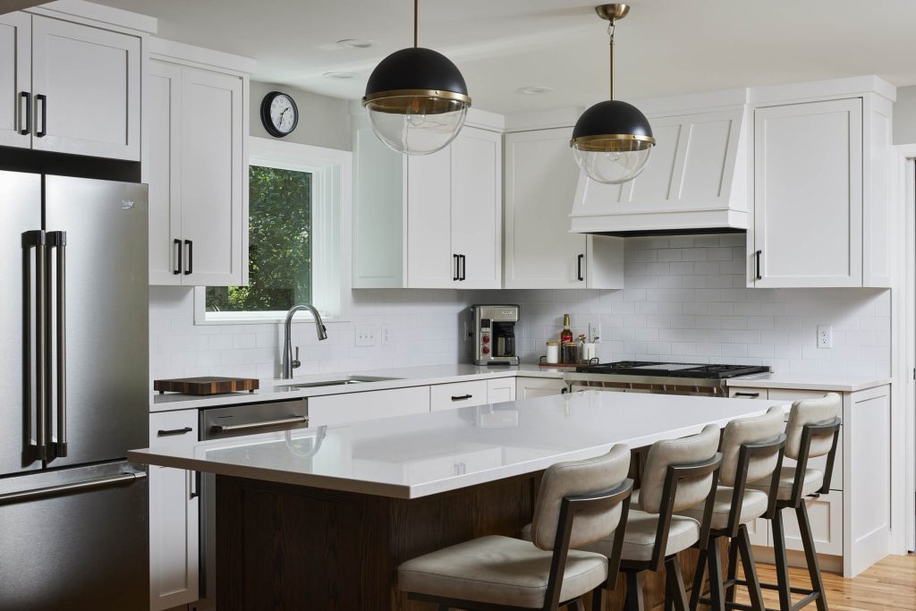 Kitchen remodel in St. Louis Park, Minnesota featuring a red oak stained island and a hidden pantry in modern farmhouse style.