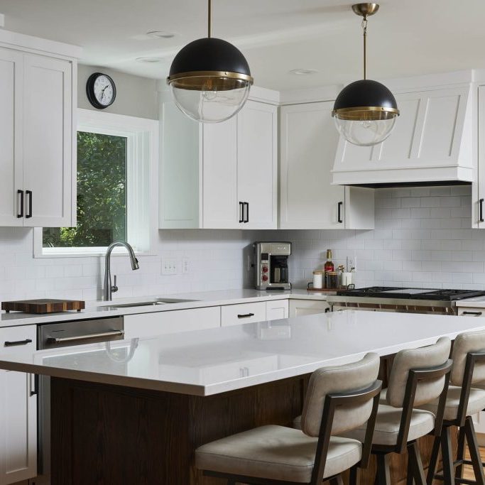 Tollefson 2 Kitchen remodel in St. Louis Park, Minnesota featuring a red oak stained island and a hidden pantry in modern farmhouse style.